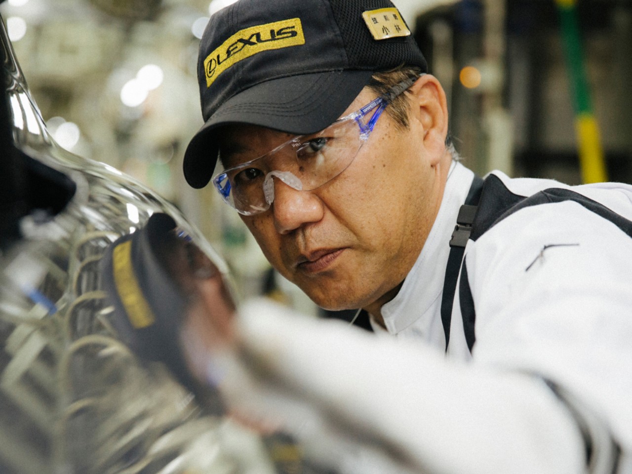 A Takumi master inspecting a Lexus